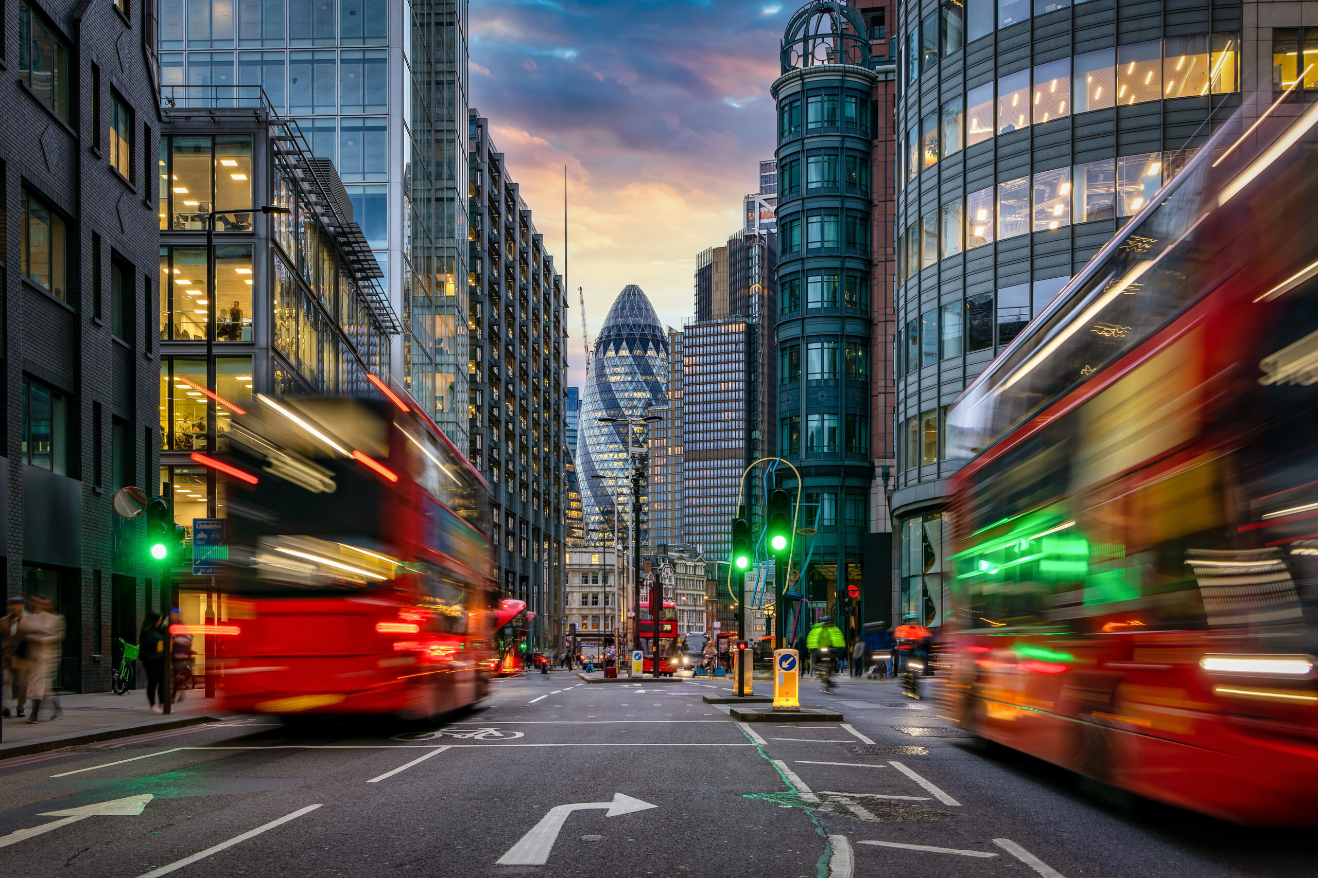 Sunset at the City of London, England, with street traffic light